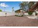 Charming backyard with gazebo, gravel, white fence, and lush trees, creating a serene outdoor space at 641 N 61St Pl, Mesa, AZ 85205