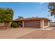 Single story home featuring an attached two car garage and well-maintained landscaping at 641 N 61St Pl, Mesa, AZ 85205