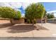 Charming single-story home with mature trees and a well-maintained yard at 641 N 61St Pl, Mesa, AZ 85205