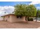 Charming single-story home with mature trees and a well-maintained yard on a sunny day at 641 N 61St Pl, Mesa, AZ 85205