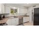 Well-lit kitchen featuring laminate countertops, tile floors and white cabinetry at 641 N 61St Pl, Mesa, AZ 85205