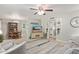 Open living room offering tile floors, a ceiling fan and views into the kitchen and dining area at 641 N 61St Pl, Mesa, AZ 85205