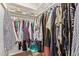 Image shows a walk-in closet with clothing hung and folded on the shelves at 641 N 61St Pl, Mesa, AZ 85205