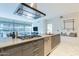 Modern kitchen with stainless steel appliances, a sleek range hood, and a view to the living room beyond at 7180 E Kierland Blvd # 807, Scottsdale, AZ 85254