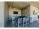 Outdoor kitchen area with countertop seating and mounted tv; an ideal spot for entertaining at 7180 E Kierland Blvd # 807, Scottsdale, AZ 85254