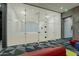 Modern squash court enclosed in glass, with painted white brick walls and recessed lighting at 7180 E Kierland Blvd # 807, Scottsdale, AZ 85254