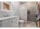 Modern bathroom with a walk-in shower, neutral tiling, and updated fixtures at 7482 S Mccormick Way, Queen Creek, AZ 85142