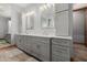 Double vanity with custom gray cabinets and stone countertops at 7482 S Mccormick Way, Queen Creek, AZ 85142