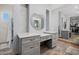 Bathroom vanity with custom cabinets, a round mirror, and tile floor at 7482 S Mccormick Way, Queen Creek, AZ 85142