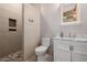 Elegant bathroom featuring a walk-in shower, marble counters, a mirror, and modern fixtures at 7482 S Mccormick Way, Queen Creek, AZ 85142