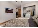 Comfortable bedroom features a patterned bedspread and an organized closet with built-in shelving for optimal storage at 7482 S Mccormick Way, Queen Creek, AZ 85142