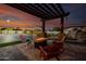 Outdoor fire pit seating area with custom overhead pergola at 7482 S Mccormick Way, Queen Creek, AZ 85142