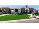 Striking front exterior with stone accents, manicured lawn, and inviting curb appeal at 7482 S Mccormick Way, Queen Creek, AZ 85142