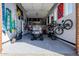 Spacious garage equipped with storage racks, hanging bikes, and parked golf cart at 7482 S Mccormick Way, Queen Creek, AZ 85142