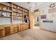 Spacious home office with custom built-ins, wood cabinets, carpet, and natural light, perfect for productivity at 7482 S Mccormick Way, Queen Creek, AZ 85142