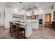 Spacious kitchen features an island with bar seating and marble countertops at 7482 S Mccormick Way, Queen Creek, AZ 85142