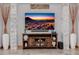 Entertainment center with a flat-screen TV, decorative vases, and a stone backsplash at 7482 S Mccormick Way, Queen Creek, AZ 85142