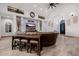 Bright and airy living room showcasing a large sectional, entertainment center, and tiled floors at 7482 S Mccormick Way, Queen Creek, AZ 85142