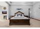 Spacious main bedroom with a decorative headboard, soft carpet, and stylish lighting, featuring a serene ambiance at 7482 S Mccormick Way, Queen Creek, AZ 85142