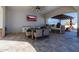 Outdoor kitchen and dining area under a covered patio with TV, grill and comfortable seating at 7482 S Mccormick Way, Queen Creek, AZ 85142