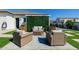 Outdoor seating area featuring wicker furniture, a privacy wall and an artificial turf at 7482 S Mccormick Way, Queen Creek, AZ 85142