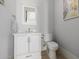 Elegant powder room featuring white vanity with carrara top and brushed gold hardware at 7482 S Mccormick Way, Queen Creek, AZ 85142