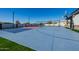 Full-sized sports court with basketball hoops and tennis net for year-round play and Gathering fun at 7482 S Mccormick Way, Queen Creek, AZ 85142