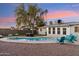 Backyard pool with Adirondack chairs, patio furniture, desert landscaping, and string lights in a tranquil setting at 7729 E Catalina Dr, Scottsdale, AZ 85251