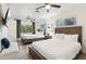 Bedroom with two beds, neutral decor, ceiling fan, and natural light from the window at 7729 E Catalina Dr, Scottsdale, AZ 85251