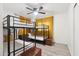 Bedroom with bunk beds, wood-look flooring, yellow curtains, and storage ottoman at 7729 E Catalina Dr, Scottsdale, AZ 85251