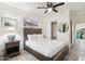 Bedroom features a wooden bed frame, neutral walls, ceiling fan, and a side table at 7729 E Catalina Dr, Scottsdale, AZ 85251