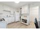 Another angle of kitchen with white appliances, classic cabinets and wood-look floors at 7729 E Catalina Dr, Scottsdale, AZ 85251