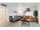 Bright living room featuring two leather sofas, decorative pillows, and a modern coffee table at 7729 E Catalina Dr, Scottsdale, AZ 85251