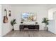 Bright living room with hardwood floors, TV, plants, and wall decor creating a cozy atmosphere at 7729 E Catalina Dr, Scottsdale, AZ 85251