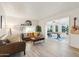 Bright living room features wood flooring, a leather sofa, and a decorative 'Arizona' wall design at 7729 E Catalina Dr, Scottsdale, AZ 85251