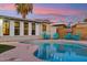 Outdoor pool area with palm tree, colorful Adirondack chairs, and string lights at 7729 E Catalina Dr, Scottsdale, AZ 85251