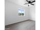 Bright bedroom featuring a window, ceiling fan, and wood floors, providing a modern, simple design at 8220 N 35Th Ave, Phoenix, AZ 85051