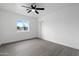 Bedroom featuring a window, ceiling fan, closet, and wood floors providing a modern, simple design at 8220 N 35Th Ave, Phoenix, AZ 85051