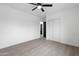 Bedroom featuring a ceiling fan, closet, and wood floors providing a modern, simple design at 8220 N 35Th Ave, Phoenix, AZ 85051