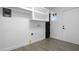 Well-organized laundry room with overhead shelves, gray vinyl flooring, and utility connections at 8220 N 35Th Ave, Phoenix, AZ 85051