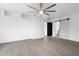 Spacious living room with light wood flooring, white walls, and ceiling fan creating a modern aesthetic at 8220 N 35Th Ave, Phoenix, AZ 85051