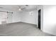 Spacious living room with light wood flooring, white walls, and ceiling fan creating a modern aesthetic at 8220 N 35Th Ave, Phoenix, AZ 85051