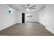 Bright living room featuring a ceiling fan, wood floors, and fresh white paint throughout at 8220 N 35Th Ave, Phoenix, AZ 85051