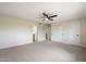 Large bedroom with neutral carpet, a ceiling fan, access to a ensuite and a walk-in closet at 8377 E Indian School Rd, Scottsdale, AZ 85251