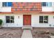 Inviting front door with colorful tile roofing on a charming, well-maintained home with clean desert landscaping at 8377 E Indian School Rd, Scottsdale, AZ 85251