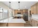 Bright kitchen features stainless steel appliances, pendant lights, and quartz countertops at 8377 E Indian School Rd, Scottsdale, AZ 85251