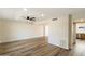 Spacious living room featuring sleek laminate wood flooring and a modern ceiling fan at 8377 E Indian School Rd, Scottsdale, AZ 85251