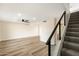 Spacious living room with modern staircase and sleek laminate wood flooring at 8377 E Indian School Rd, Scottsdale, AZ 85251