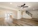 Spacious living room with modern staircase and sleek laminate wood flooring at 8377 E Indian School Rd, Scottsdale, AZ 85251