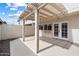 Covered patio featuring a textured concrete floor and a lattice overhang, perfect for outdoor relaxation at 8377 E Indian School Rd, Scottsdale, AZ 85251